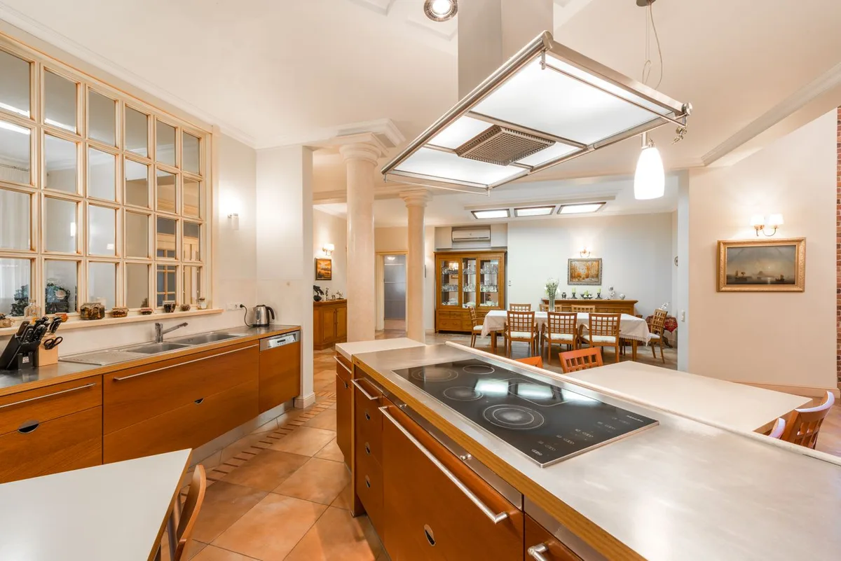 A spacious kitchen with an island and a dining table beyond